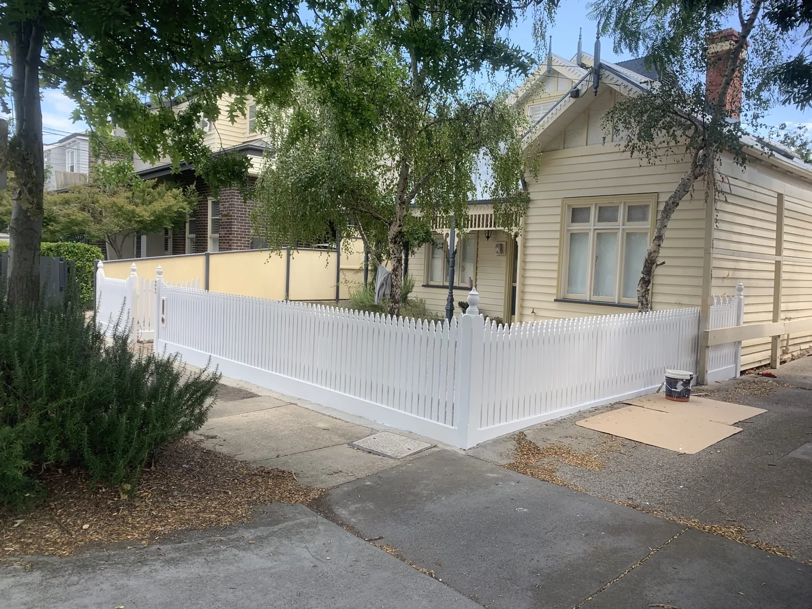 Freshly painted white timber fence at a residential property